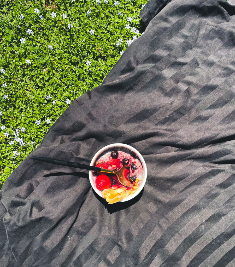 plant-based chia bowl outside with flowers