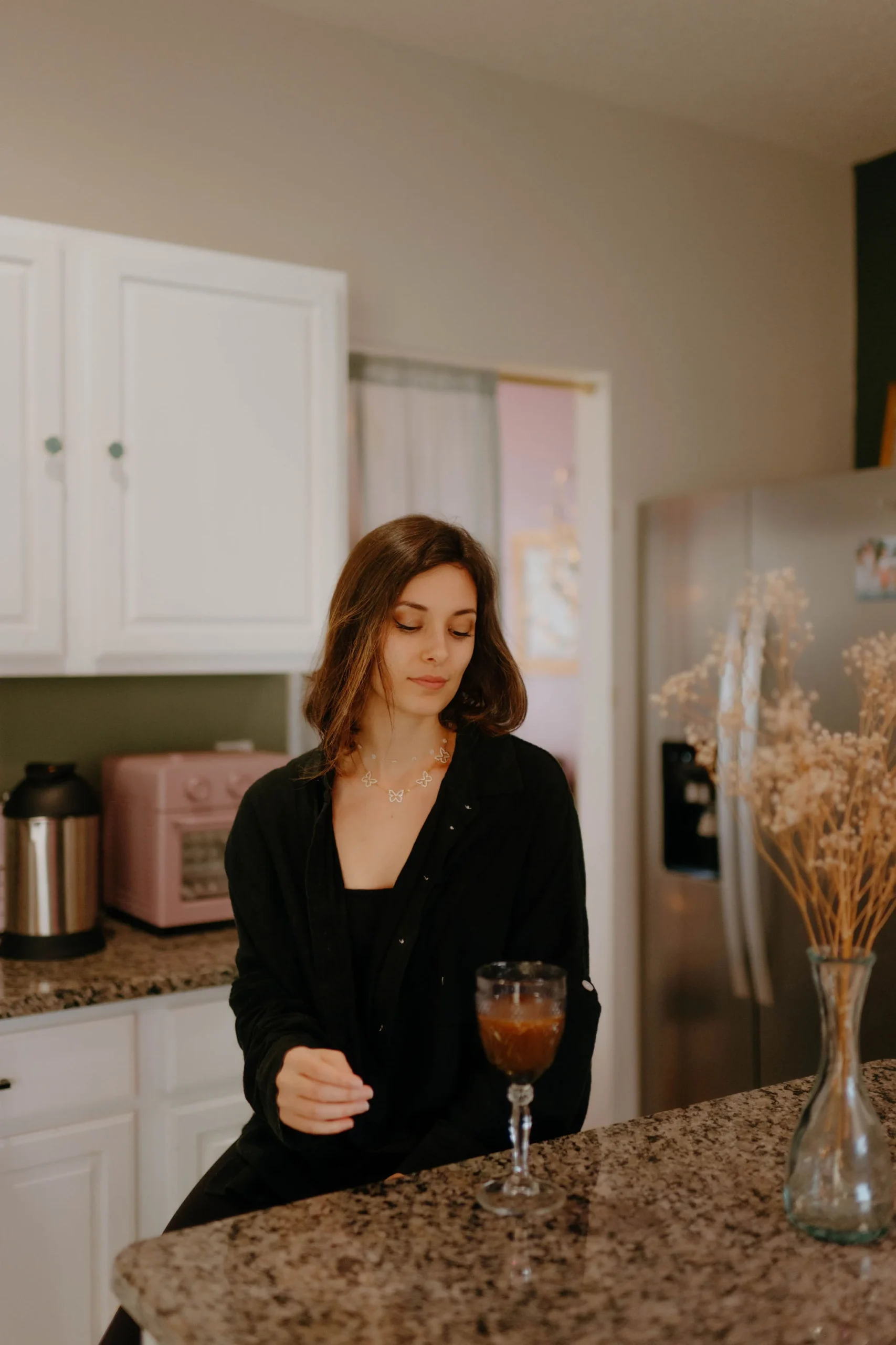 nontoxic home girl drinking juice in kitchen
