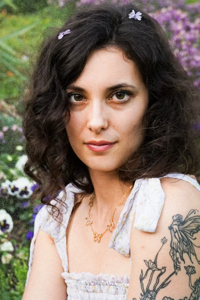 woman looking at camera with flowers in her hair